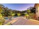 The outdoor pool and patio with tropical landscaping, under-cabinet lighting, and evening ambiance at 2434 Wood St, Sarasota, FL 34237