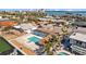 Aerial view of the property featuring a pool, tiki hut, and waterfront at 2762 W Vina Del Mar Blvd, St Pete Beach, FL 33706