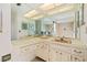 A large bathroom with double sinks and vanities at 2762 W Vina Del Mar Blvd, St Pete Beach, FL 33706