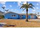 Charming single-story home with a bright blue exterior and mature palm trees in a sunny setting at 2762 W Vina Del Mar Blvd, St Pete Beach, FL 33706