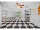 Open-concept living room with checkered floors, bright lighting, and seamless flow to other living spaces at 2762 W Vina Del Mar Blvd, St Pete Beach, FL 33706