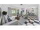 Bright living room boasts stylish decor, tile floors, and sliding glass doors to enclosed patio at 2762 W Vina Del Mar Blvd, St Pete Beach, FL 33706