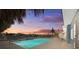 A sparkling pool at sunset with a nearby water view at 2762 W Vina Del Mar Blvd, St Pete Beach, FL 33706