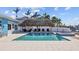 Inviting pool area with Tiki hut, lounge chairs, and a spa, perfect for outdoor relaxation and entertaining at 2762 W Vina Del Mar Blvd, St Pete Beach, FL 33706