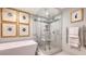 Beautiful bathroom featuring a glass shower, freestanding tub, and heated towel rack at 3060 Grand Bay Blvd # 154, Longboat Key, FL 34228