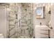 Modern bathroom with walk-in shower featuring stylish marble-look tile and glass door at 3060 Grand Bay Blvd # 154, Longboat Key, FL 34228