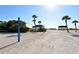Beach volleyball court on pristine white sands near the beach club pavilions with palm trees at 3060 Grand Bay Blvd # 154, Longboat Key, FL 34228