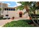 Clubhouse entrance framed by palm trees and lush landscaping at 3060 Grand Bay Blvd # 154, Longboat Key, FL 34228