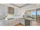 Modern kitchen featuring sleek cabinets, a stylish backsplash, stainless steel appliances, and natural light at 3060 Grand Bay Blvd # 154, Longboat Key, FL 34228