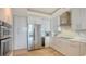 Contemporary kitchen boasts ample storage, modern appliances, and sleek countertops at 3060 Grand Bay Blvd # 154, Longboat Key, FL 34228