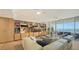 Relaxing living room featuring water views, built-in shelving, and comfortable seating at 3060 Grand Bay Blvd # 154, Longboat Key, FL 34228