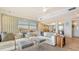 Spacious living room featuring a large sofa, modern art, stylish decor, and plenty of natural light at 3060 Grand Bay Blvd # 154, Longboat Key, FL 34228