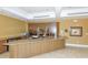 Community lounge area with bar, counter seating, and kitchenette at 3060 Grand Bay Blvd # 154, Longboat Key, FL 34228