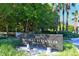 Bay Isles Beach Club sign in front of lush green trees at 3060 Grand Bay Blvd # 154, Longboat Key, FL 34228