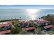 Stunning aerial view of waterfront condos with red tile roofs, lush landscaping, and panoramic ocean views at 3460 Wild Oak Bay Blvd # 145, Bradenton, FL 34210