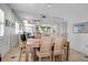 Bright dining room with a wooden table, seating for six, and a mirrored wall at 3460 Wild Oak Bay Blvd # 145, Bradenton, FL 34210