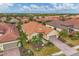 An aerial shot of a home with beautiful landscaping, tile roof and two-car garage in a vibrant community at 5116 Tivoli Run, Bradenton, FL 34211