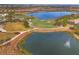 Amazing aerial view showcasing the lake and golf course of the community at 5116 Tivoli Run, Bradenton, FL 34211