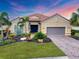 Charming single-story home featuring a well-manicured lawn with professional landscaping and a two-car garage at 5116 Tivoli Run, Bradenton, FL 34211