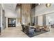 Modern lobby area with comfortable seating, stone accents, wood paneling, and stylish decor at 5116 Tivoli Run, Bradenton, FL 34211