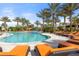 A large community pool with palm trees and lounge chairs at 5116 Tivoli Run, Bradenton, FL 34211