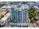 Stunning aerial view of a high-rise condo building with a rooftop pool and panoramic city views at 540 N Tamiami Trl # 802, Sarasota, FL 34236