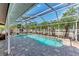 Inviting in-ground pool with screened enclosure, surrounded by lush landscaping and patio area at 5708 39Th Street E Cir, Bradenton, FL 34203