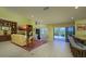 Bright living room featuring an open floor plan, fireplace, and views of the outdoor pool at 716 Tropical Cir, Sarasota, FL 34242