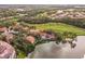 Stunning aerial view of luxurious homes along a scenic golf course and serene lake at 7460 Monte Verde, Sarasota, FL 34238