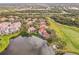 Aerial view of neighborhood homes, golf course, and pond at 7460 Monte Verde, Sarasota, FL 34238