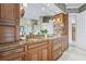 An expansive bathroom features dual sinks, granite counters and a large vanity with wood cabinets at 7460 Monte Verde, Sarasota, FL 34238