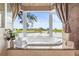 Relaxing bathroom with a garden tub, bay window, and serene views of the golf course and water at 7460 Monte Verde, Sarasota, FL 34238