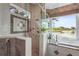 Luxurious bathroom with glass shower enclosure, large soaking tub and a beautiful lake view at 7460 Monte Verde, Sarasota, FL 34238