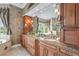 Well-appointed bathroom with dual sinks, granite countertops, custom cabinets, and large mirrors at 7460 Monte Verde, Sarasota, FL 34238