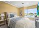 Bright bedroom with lake views, a comfortable bed, and soft blue accents at 7460 Monte Verde, Sarasota, FL 34238