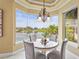 Charming breakfast nook surrounded by large windows, offering serene water views at 7460 Monte Verde, Sarasota, FL 34238