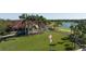Elegant clubhouse surrounded by lush landscaping, palms, and an American flag at 7460 Monte Verde, Sarasota, FL 34238