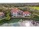 Beautiful waterfront home with a red tile roof, screened lanai and lush landscaping at 7460 Monte Verde, Sarasota, FL 34238