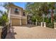 Elegant two-story home featuring a brick driveway, a two-car garage, and beautiful landscaping at 7460 Monte Verde, Sarasota, FL 34238