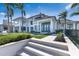 Impressive backyard with manicured lawn, pool and a white home with blue trim at 8501 Midnight Pass Rd, Sarasota, FL 34242
