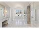 Spacious bathroom with a soaking tub, marble floors, a vanity, and walk-in shower at 8501 Midnight Pass Rd, Sarasota, FL 34242