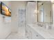 Bright bathroom features a marble countertop, chrome fixtures, and a glass-enclosed shower at 8501 Midnight Pass Rd, Sarasota, FL 34242