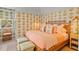 Charming bedroom with pineapple wallpaper and coordinated bedding for a cozy and tropical feel at 8501 Midnight Pass Rd, Sarasota, FL 34242