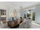 Formal dining room with large windows and elegant chandelier at 8501 Midnight Pass Rd, Sarasota, FL 34242