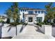 Beautiful home with a grand entrance, detailed trim, and manicured landscaping at 8501 Midnight Pass Rd, Sarasota, FL 34242
