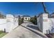 Grand gated entrance with a long driveway leading to a beautiful home and manicured landscaping at 8501 Midnight Pass Rd, Sarasota, FL 34242