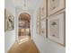 Bright hallway with wood floors, palm tree prints, and bar in the background at 8501 Midnight Pass Rd, Sarasota, FL 34242