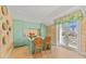 Bright kitchen featuring mint green cabinets, a central island, and French doors to a balcony at 8501 Midnight Pass Rd, Sarasota, FL 34242