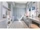 Well-equipped laundry room with custom cabinetry and modern appliances at 8501 Midnight Pass Rd, Sarasota, FL 34242