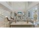 Bright living room with soaring ceilings, fireplace, and elegant decor, creating a luxurious ambiance at 8501 Midnight Pass Rd, Sarasota, FL 34242